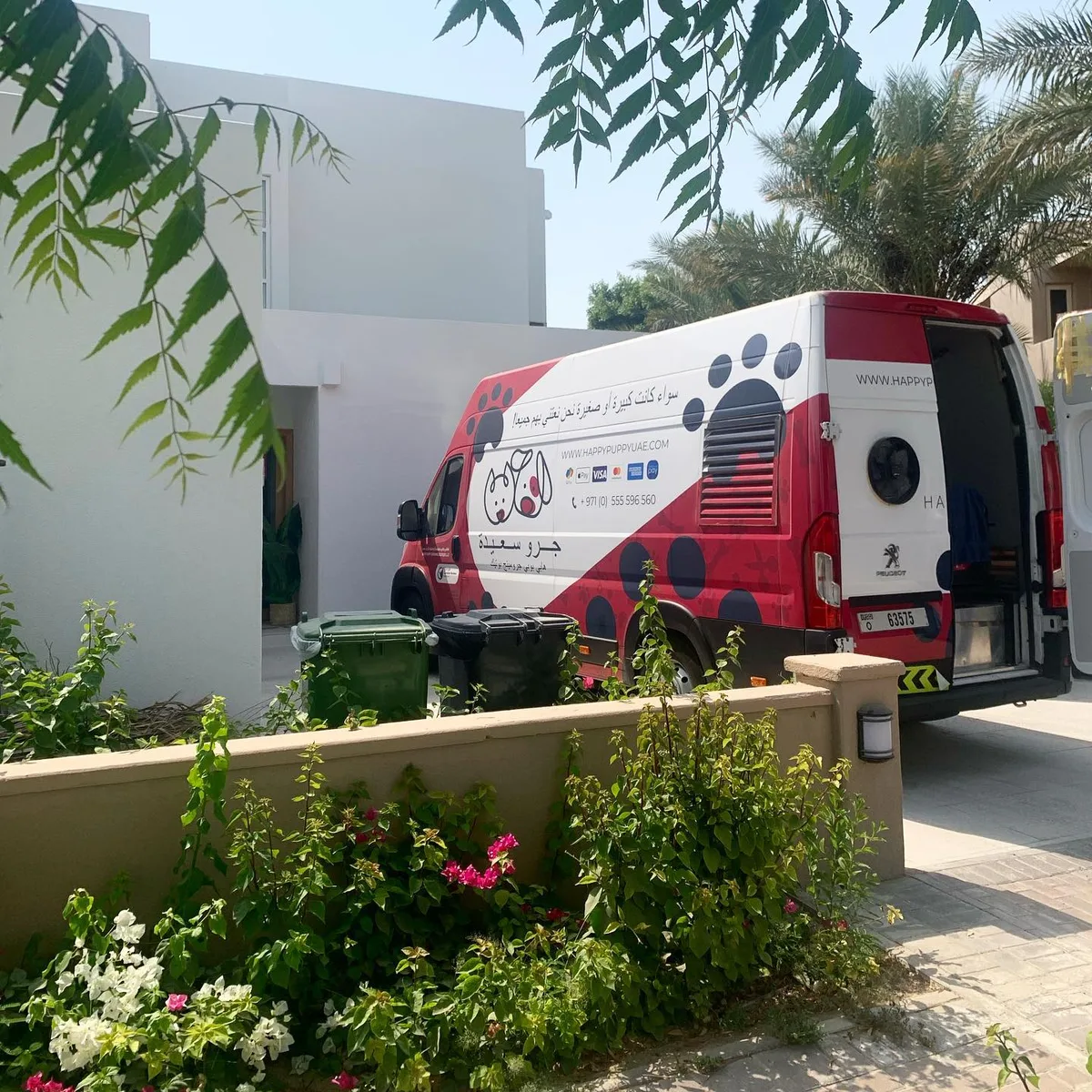 Happy Puppy pet salon van parked on a villa driveway in Dubai