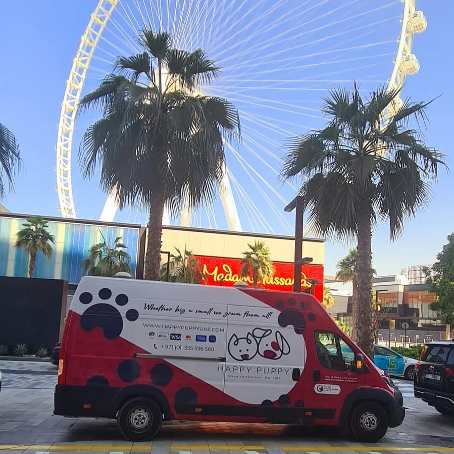 Happy Puppy mobile grooming van parked near Jumeirah Beach Residence in Dubai