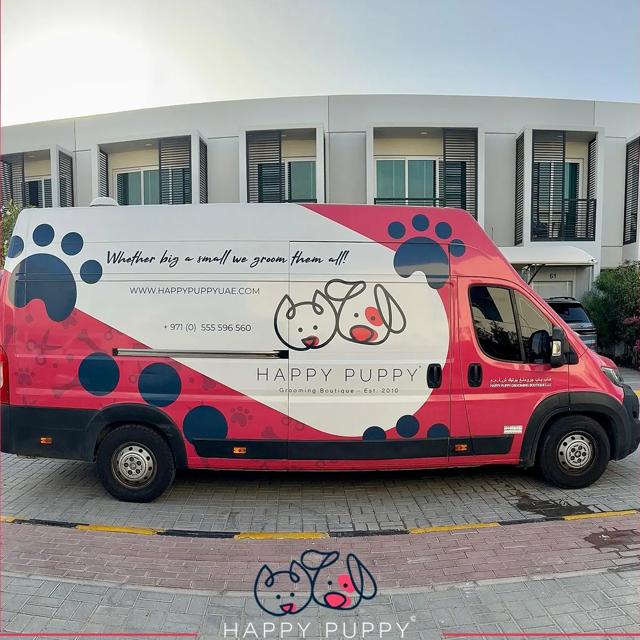 Happy Puppy grooming van parked outside townhouses in Dubai